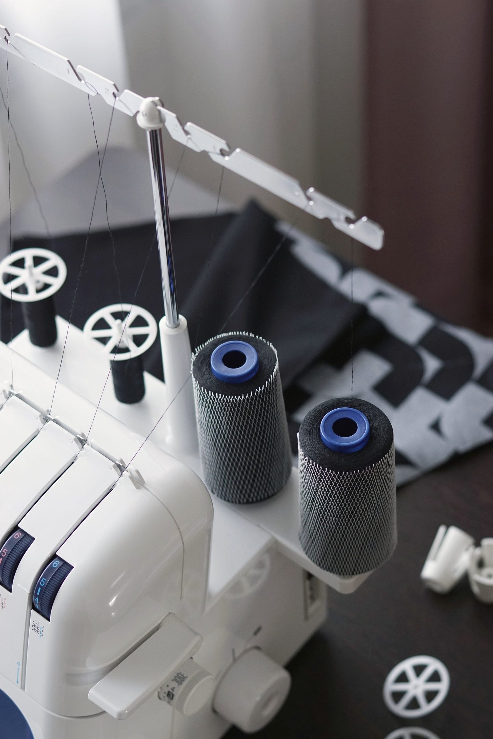 Thread guides and spools on the head of an industrial machine.