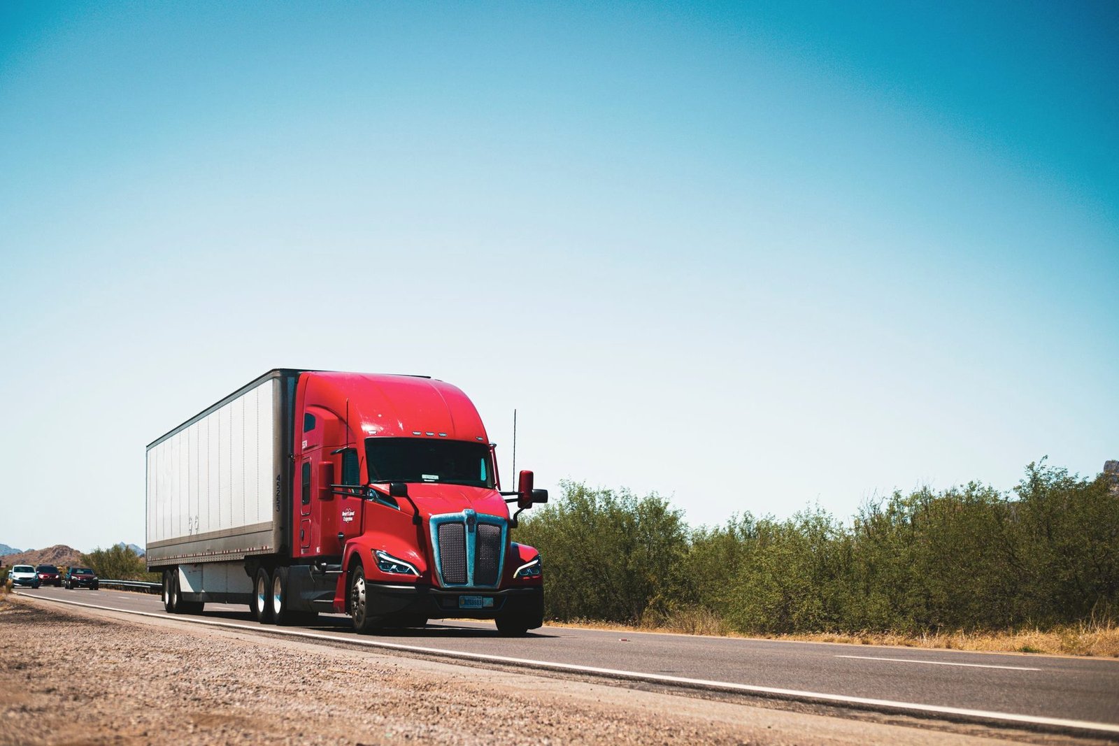 A heavy truck and trailer on an open highway.